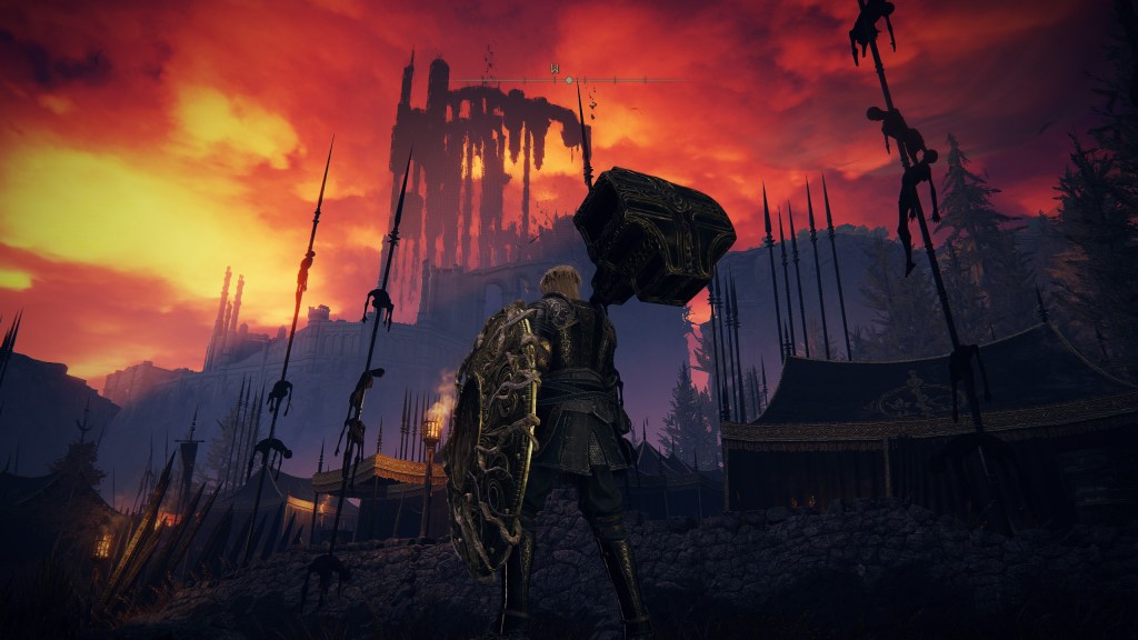 A tarnished warrior stands in one of the camps of Messmer's army. Long spears are planted in the ground, several scorched bodies impaled on each. Above, shadows obscure ruins that spiral upward into the burning red sky.