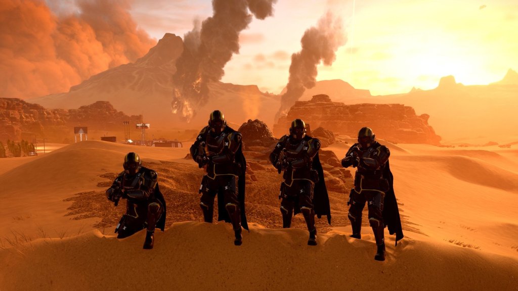 4 Helldivers pose in front of a scorched desert wasteland.