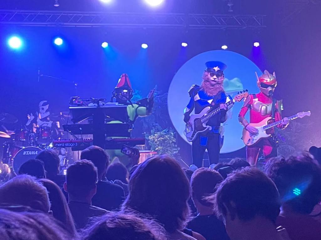 A photo of TWRP performing at the Cat's Cradle in Chapel Hill. Pictured left to right: Havve Hogan, Doctor Sung, Commander Meouch, Lord Phobos.